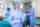 Portrait of female woman nurse surgeon OR staff member dressed in surgical scrubs gown mask and hair net in hospital operating room theater