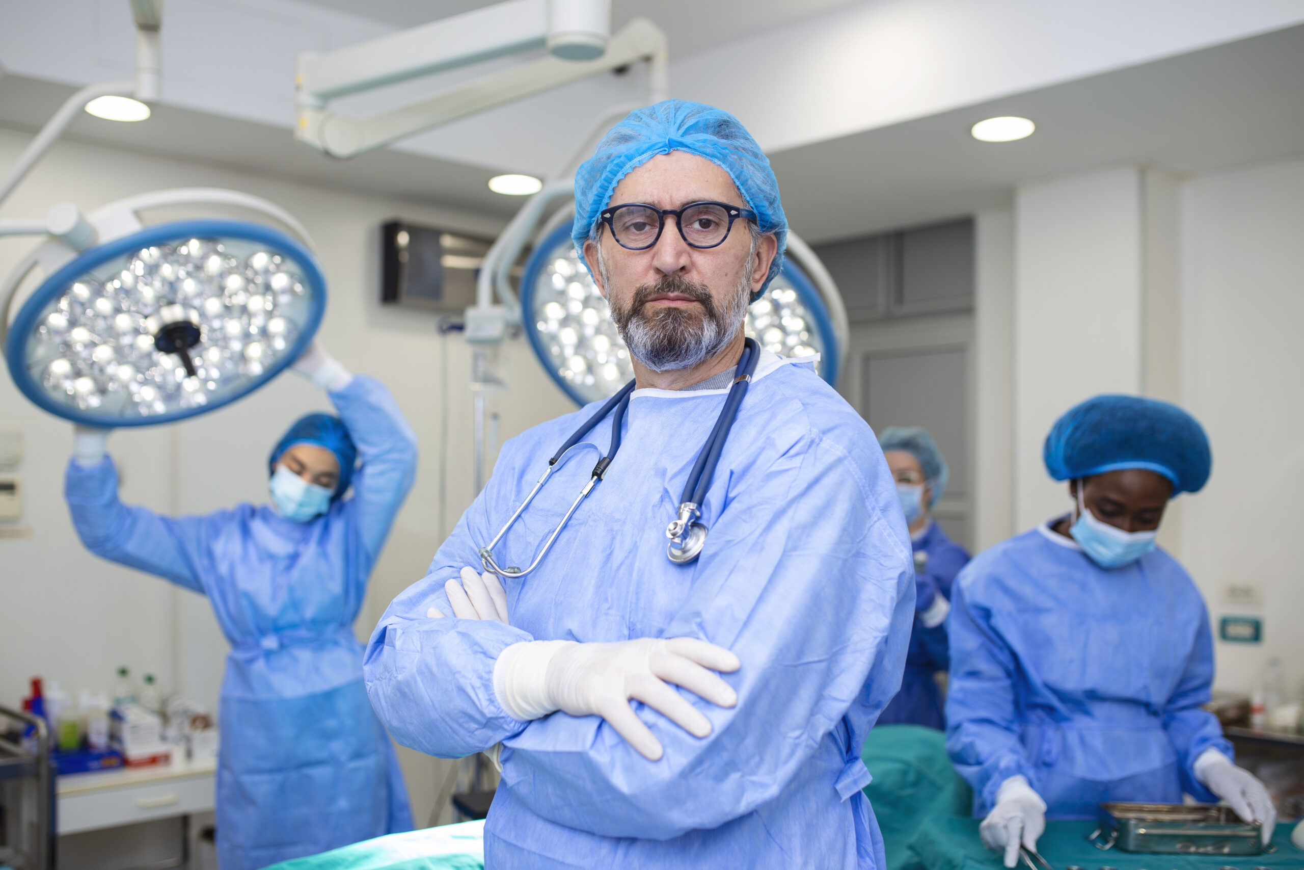 Portrait of male surgeon in operation theater at hospital. Healthcare workers in the Coronavirus Covid19 pandemic