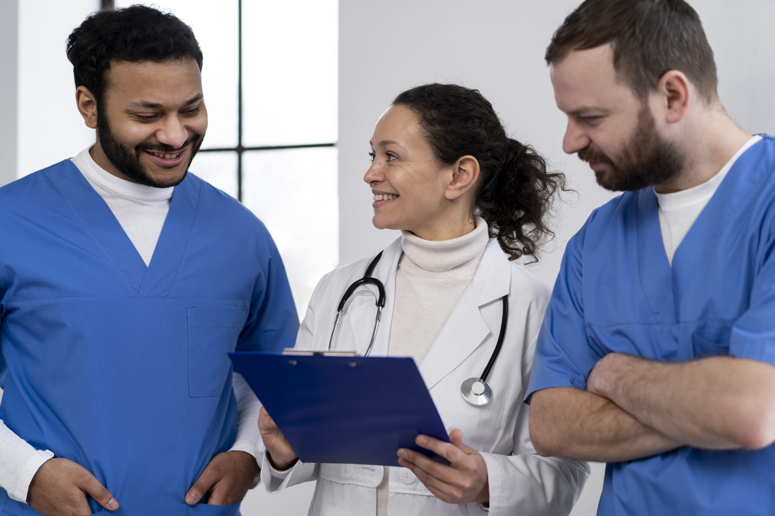 smiley-nurses-discussing-with-doctor-medium-shot